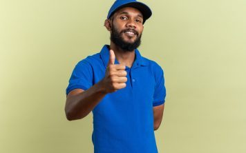 pleased-young-delivery-man-thumbing-up-isolated-olive-green-wall-with-copy-space-qabbq7am030b70mdjzzz47pu5y9drg2jlxbl81fxrg